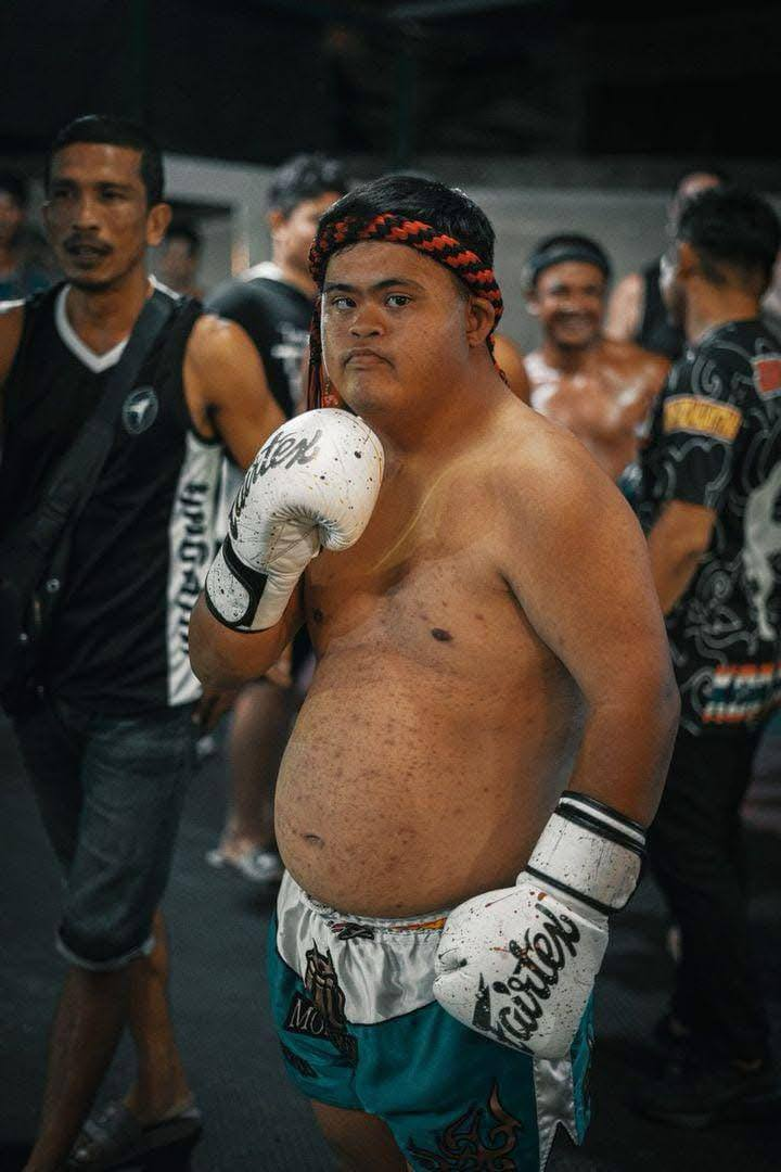 Super Mark in a fighting pose with boxing gloves on, ready for a match